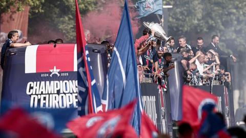 PSG's players celebrate their Champions League title with an open top 