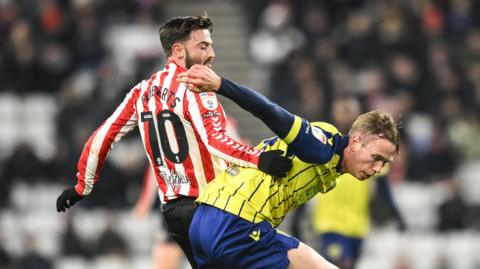 Sunderland's Patrick Roberts tussles with West Brom defender Thorbjorn Heggem