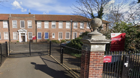 The entrance to King Edward VI School in Bury St Edmunds. It is gated. 