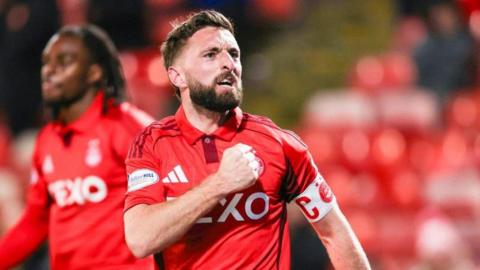 Captain Graeme Shinnie celebrates making it 2-0 to Aberdeen