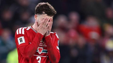 Wales defender Neco Williams with his head in his hands after missing a penalty against Bosnia