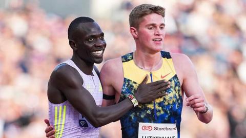 Emmanuel Wanyonyi taps Cooper Lutkenhaus on the chest after their race