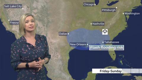 Sarah Keith-Lucas stands in front of a weather map of the US