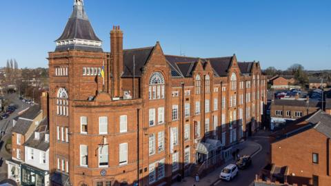A red-brick Victorian-style large former factory 