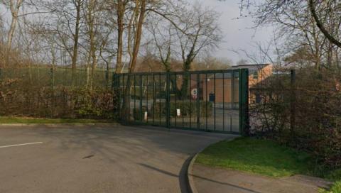Street view of green school gates in Eckington.