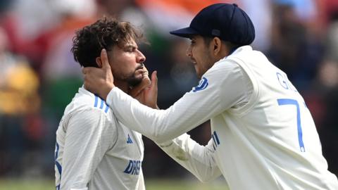 India spinner Kuldeep Yadav (left) is congratulated Shubman Gill (right) after taking a wicket