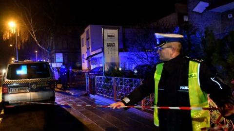 Police secure a scene of a fire in Koszalin, Poland, 4 January 2019