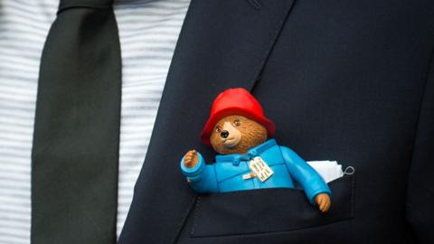 Paddington Bear toy in jacket pocket
