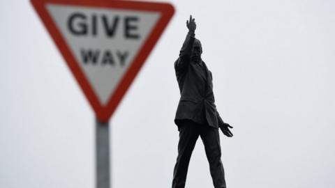 A give way sign beside the statue of Edward Carson at Stormont