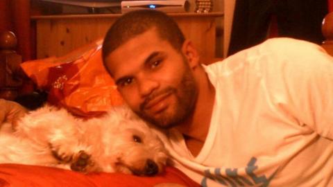 Simeon Francis lying next to a dog