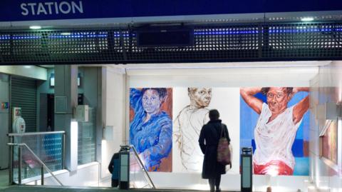 Claudette Johnson's painting of three black women inside Brixton Tube station, with a passenger in the foreground.   