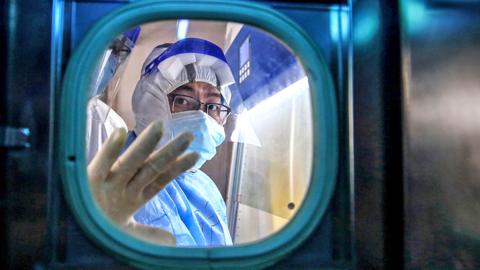 A medical staff member gestures inside an isolation ward at Red Cross Hospital in Wuhan in China's central Hubei province on March 10, 2020