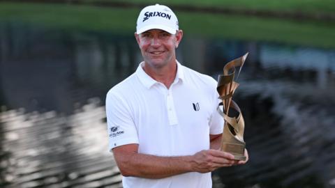 Lucas Glover posing with the St Jude Champonship trophy