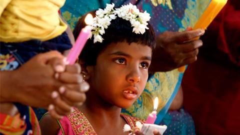 Indian Christians taking part in Christmas prayers at the Infant Jesus church in Bangalore, India