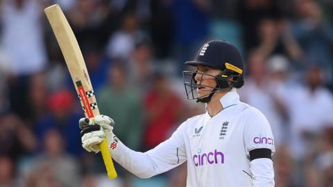 England opener Zak Crawley raises his bat after reaching his fifty