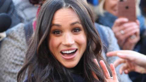 Megan Markle smiles and waves at crowd