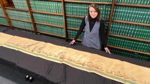 Senior librarian Rhian Isaac with the document