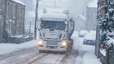 Lorry drives through snow