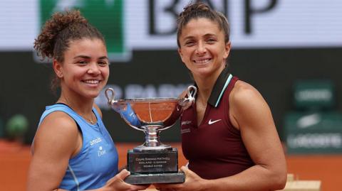 Jasmine Paolini and Sara Errani holds the French Open women's doubles trophy