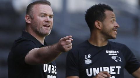 Wayne Rooney (left) and Liam Rosenior encourage the Derby players