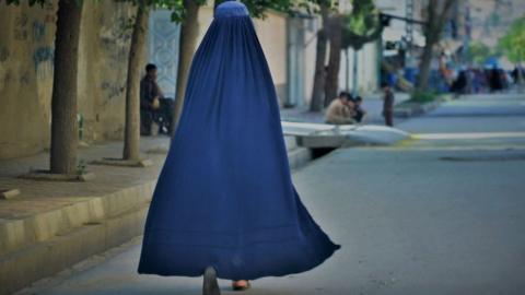 A woman walks down the street in Kabul in May 2022 (file picture)