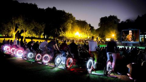 Row of cyclists at film screening