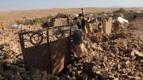 A stand in the rubble of a building after earthquake earlier this week in Herat province, Afghanistan. Photo: 12 October 2023