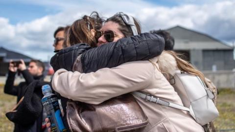 Relatives of people aboard the Chilean Air Force C-130 Hercules cargo plane that went missing in the sea between the southern tip of South America and Antarctica, embrace at Chabunco army base in Punta Arenas, Chile, on December 11, 2019