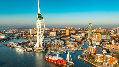 Aerial view of Portsmouth's spinnaker tower and harbour at sunrise