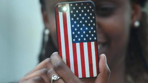 A smartphone in a case showing the US flag