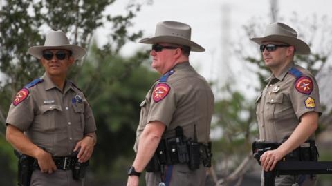 Officers with the Allen Police Department block an entrance to the mal