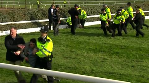 Protesters and police at Aintree racecourse