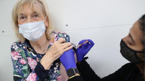 A woman is vaccinated in Streatham, south London