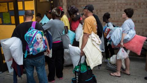 People line up to enter a hurricane shelter in North Carolina on September 11 2018. More than one million have been told to leave their homes