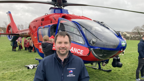 Graham Coates in front of an air ambulance