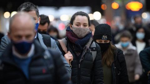 Masked woman in crowd