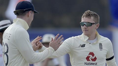 England's Dom Bess celebrates with Dan Lawrence after taking a wicket v Sri Lanka