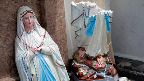 A statue of Virgin Mary broken in two parts at the St. Anthony's Shrine, Kochchikade church in Colombo