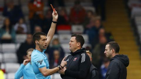 Exeter boss Gary Caldwell is shown the red card at Lincoln