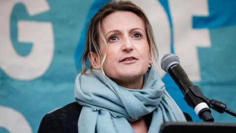 A file photo of Melissa Green speaking into a microphone during an event.