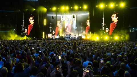 Damon Albarn of Blur and Phil Daniels performing on stage at Wembley Stadium in London