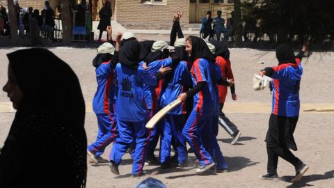 Afghan girls celebrate after a school cricket match in September 2013