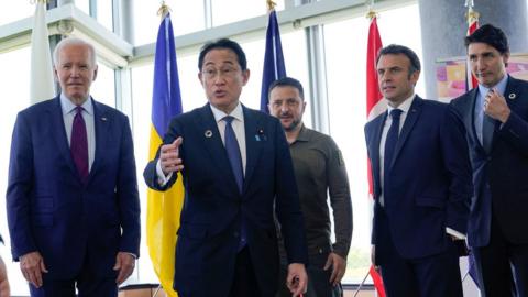 Japanese Prime Minister Fumio Kishida, gestures following a photo with President Joe Biden, Ukrainian President Volodymyr Zelenskiy, French President Emmanuel Macron, and Canadian Prime Minister Justin Trudeau