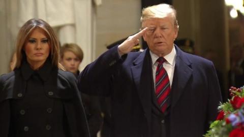 Donald Trump salutes George HW Bush's casket