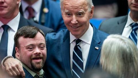 Joe Biden and James Martin smile as they pose for a photograph