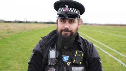 Police officer wearing uniform and beard