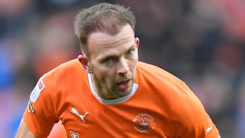 Jordan Rhodes playing football for Blackpool against Portsmouth