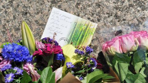 Flowers and tribute messages left near the site of the Grenfell Tower disaster