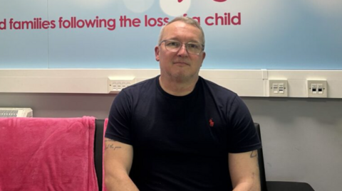 Rob Lapsley, a middle-aged man with glasses.