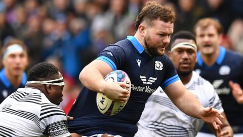 Ewan Ashman evades a tackle while playing for Scotland against Fiji